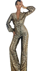 A woman in a Nik Spruill Savage Sheen leopard print jumpsuit.