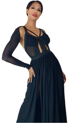 A woman wearing Nik Spruill's Session sheer strappy maxi dress in black with sheer sleeves.