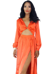 A woman wearing a Nik Spruill Effortless Double Slit Maxi Dress - Orange.