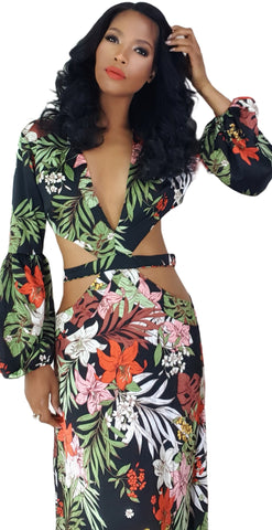 A woman in a Nik Spruill Shanti cutout flower maxi dress posing for a picture.