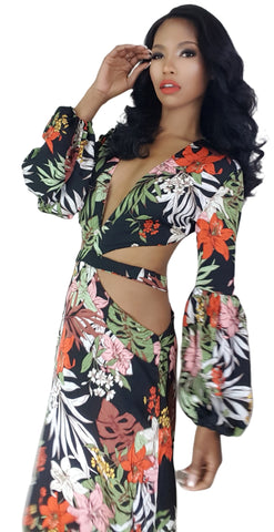 A woman in a Nik Spruill Shanti cutout flower maxi dress posing for a picture.
