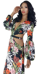 A woman in a Nik Spruill Shanti cutout flower maxi dress posing for a picture.