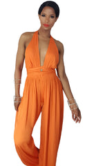 A woman in a Nik Spruill "The fearless one deep plunge backless jumpsuit - orange" posing for a picture.