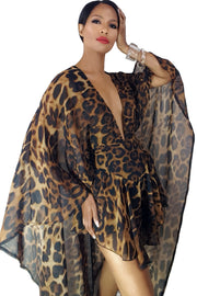 A woman is posing in a Monte Leopard Print Cape Romper by Nik Spruill.