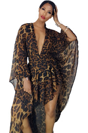 A woman wearing a Nik Spruill Monte Leopard Print Cape Romper dress.