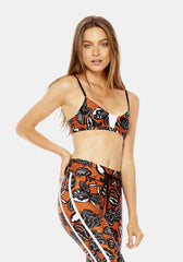 A woman in a The Upside crop top and leggings.