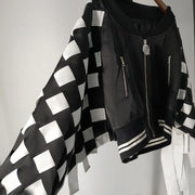 A Nik Spruill CHECKMATE FRINGE JACKET hanging on a wall.