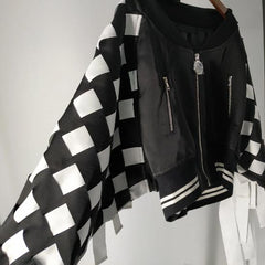A Nik Spruill CHECKMATE FRINGE JACKET hanging on a wall.