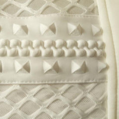 A close up of a Nik Spruill COCOON EMBRACE COAT with a bunch of rivets on it.