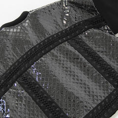 A close up of a Nik Spruill COMPLETION JACKET in black and silver.