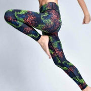 A woman is jumping in the air with her iYoga CONSTELLATION LEGGING up.