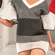 A woman walking down a runway in a Nik Spruill CONNECTION DRESS.