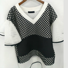 A Nik Spruill CONNECTION DRESS hanging on a wall.