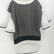 A Nik Spruill CONNECTION DRESS hanging on a wall.