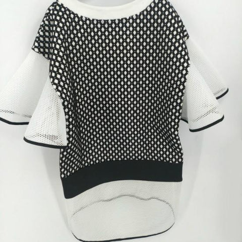A Nik Spruill CONNECTION DRESS hanging on a wall.