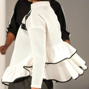 A woman walking down a runway wearing a Nik Spruill Crossroads Top.