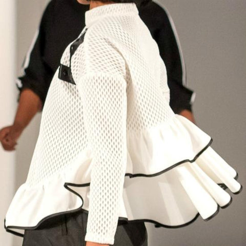 A woman walking down a runway wearing a Nik Spruill Crossroads Top.