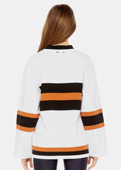 A woman wearing The Upside's Fabe Laced Top with white and black stripes.