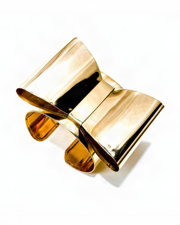 A pair of Nik Spruill ASHANTI glasses sitting on top of a book.