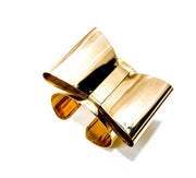 A pair of Nik Spruill ASHANTI glasses sitting on top of a book.