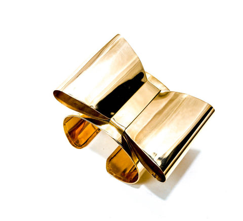 A pair of Nik Spruill ASHANTI glasses sitting on top of a book.