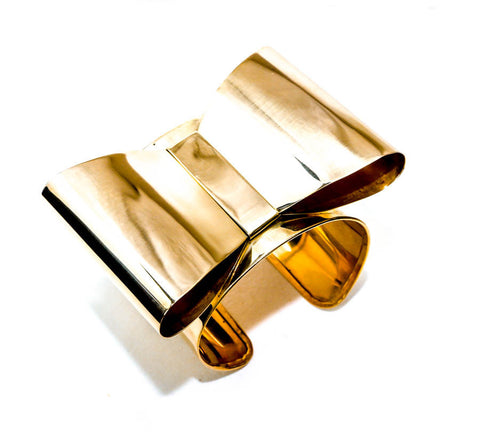 A close up of an ASHANTI metal object on a white surface by Nik Spruill.