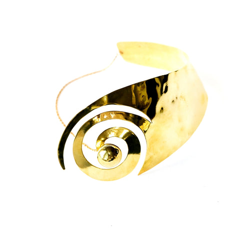 A close up of an AMENZA metal object on a white background by Nik Spruill.