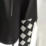 a black and white Nik Spruill jacket with a checkered design.