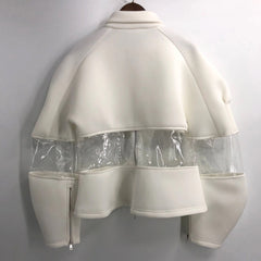 An Ocean 7 jacket by Nik Spruill hanging on a white wall.