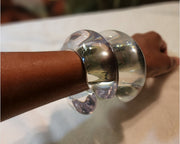 A close up of a person's arm with a Nik Spruill Bubble Cuff on it.