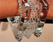 A person's arm holding a Nik Spruill FROST crystal bracelet.