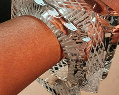 A close up of a person holding a Nik Spruill FROST glass object.