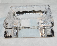 A FROSTY Nik Spruill glass dish sitting on top of a white surface.