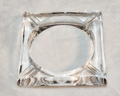 A square shaped FROSTY by Nik Spruill glass object on a white surface.