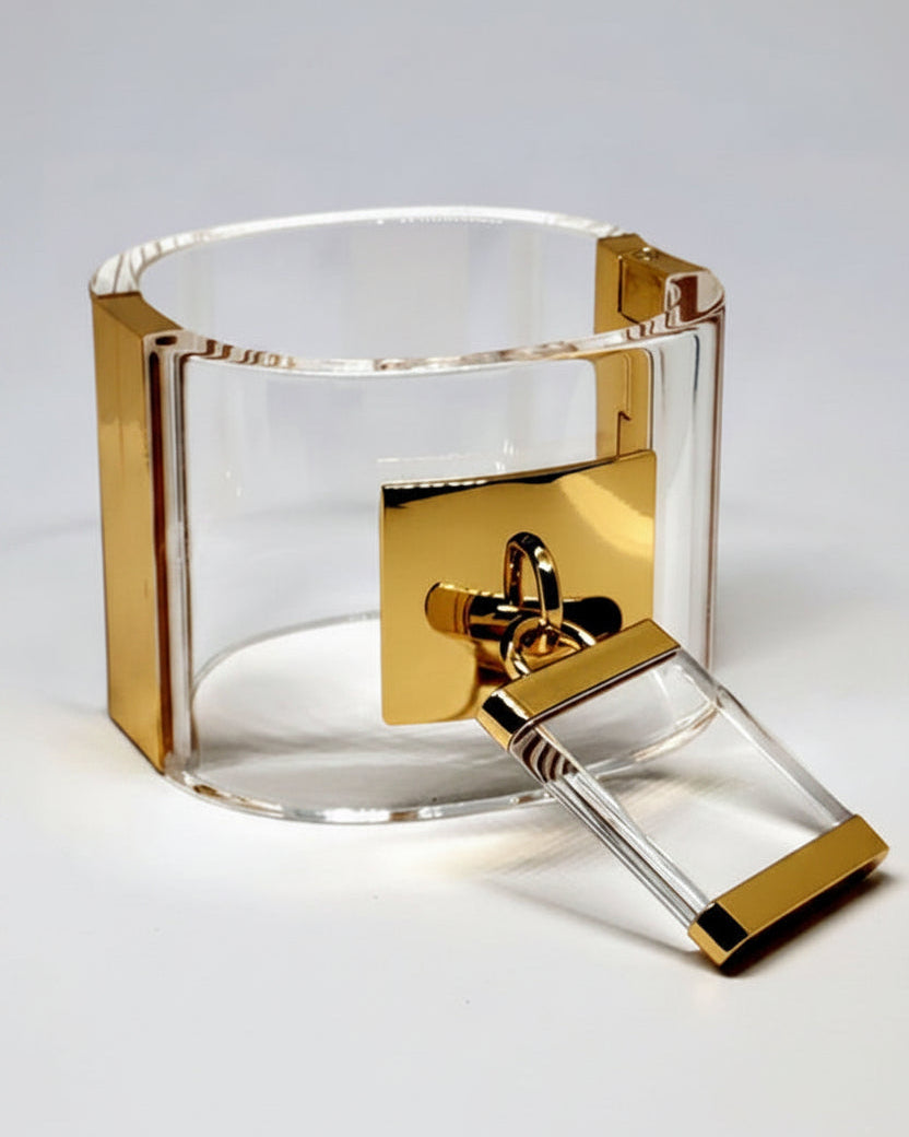 A Nik Spruill DROP - GOLD bracelet with a lock on it.