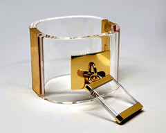 A Nik Spruill DROP - GOLD bracelet with a lock on it.