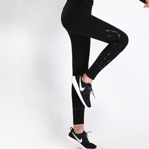 a woman wearing Nik Spruill's REBEL HIGH WAIST LEGGING BLACK and sneakers.