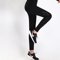 a woman wearing Nik Spruill's REBEL HIGH WAIST LEGGING BLACK and sneakers.