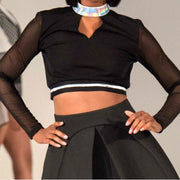 A woman in a Nik Spruill RELEASE TOP and black skirt on a runway.