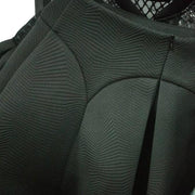 A close up of a Nik Spruill Spectator Skirt with a lace collar.