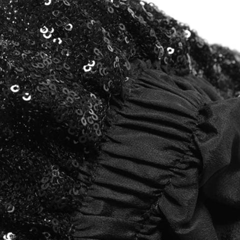 A close up of Nik Spruill's Maya relaxed fit sequined pant - black with ruffles.