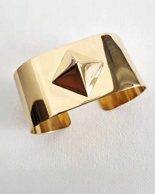 A close up of a Nik Spruill ISIS CUFF on a white surface.