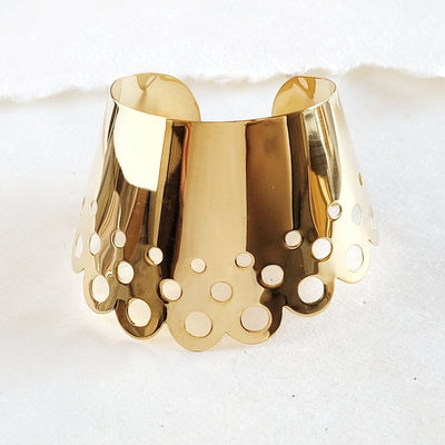 A close up of a Nik Spruill DAHOMEY CUFF on a white surface.