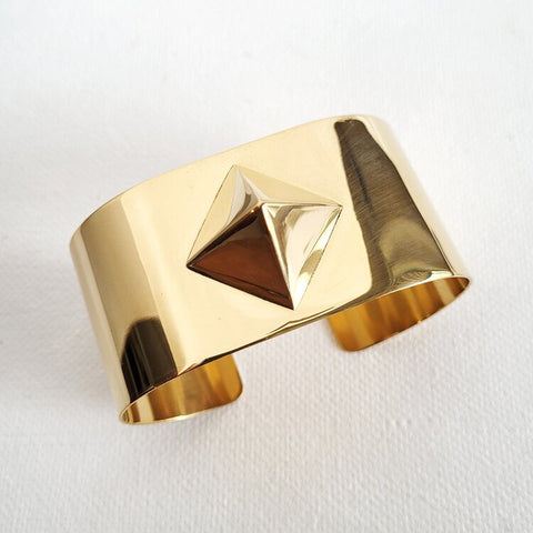A close up of a Nik Spruill ISIS CUFF on a white surface.