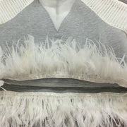 A Nik Spruill Waves top with white feathers on it.