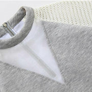 A close up of a Waves Top by Nik Spruill on a hanger.